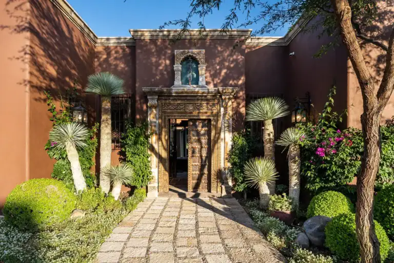 Casa de Salca, stone path to the carved entrance framed by yucca and agave, San Miguel de Allende