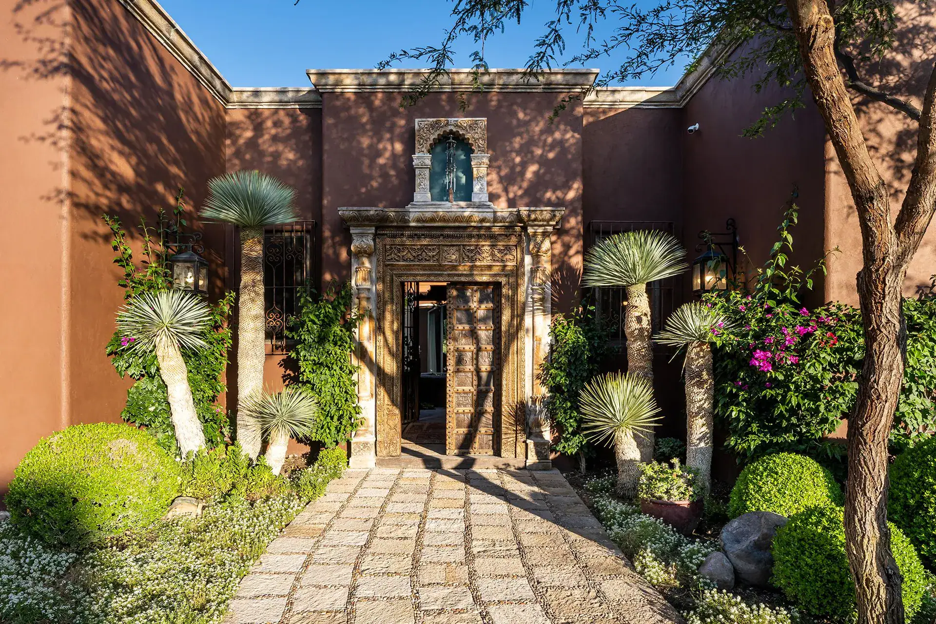 Casa de Salca, stone path to the carved entrance framed by yucca and agave, San Miguel de Allende