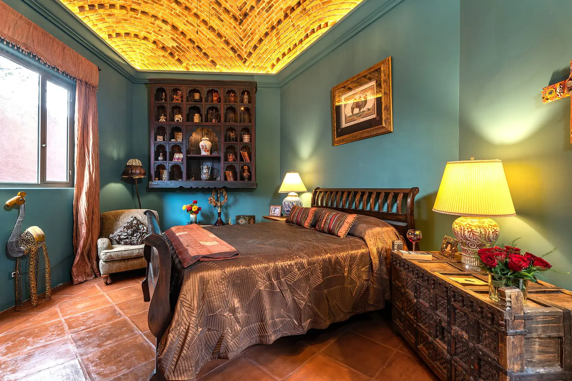 Casa de Salca, bedroom with turquoise walls and a bronze bedspread, San Miguel de Allende
