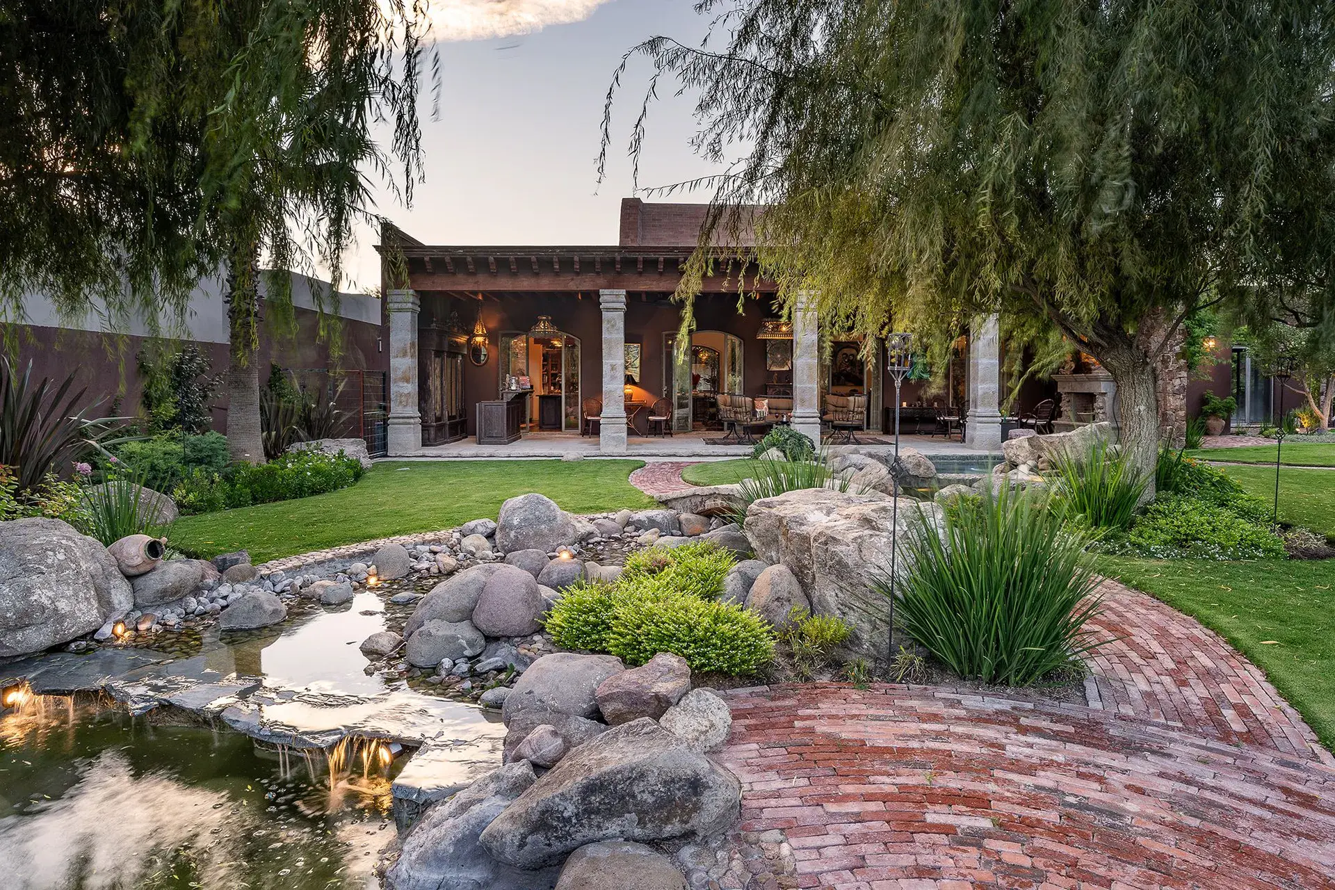 Casa de Salca, garden with a stream, a pond and a willow tree at dusk, San Miguel de Allende