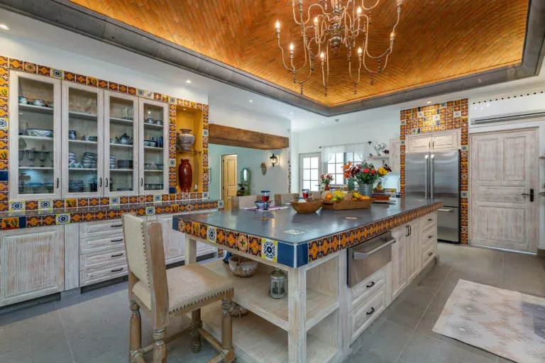 Casa del Angel, kitchen with a tiled island, talavera tile accents and a chandelier, San Miguel de Allende