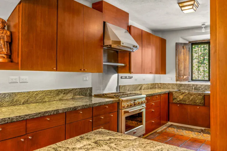 Casa del Artista, kitchen with cherry cabinets, a gas range, a stainless hood and green granite counters, San Miguel de Allende