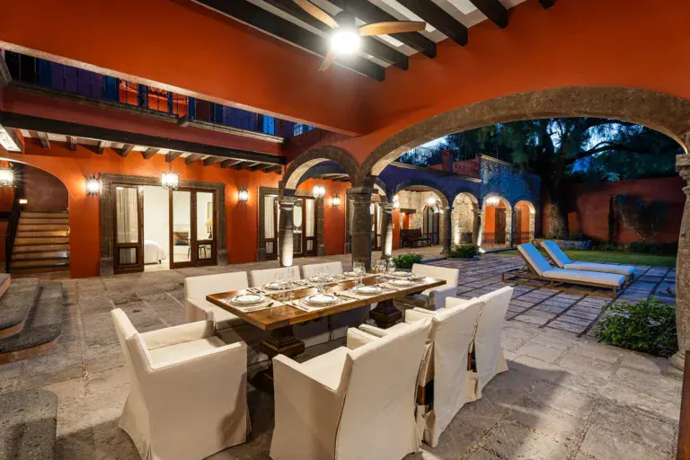 Casa Del Cardo, arcaded courtyard with an outdoor dining table set for a meal, San Miguel de Allende