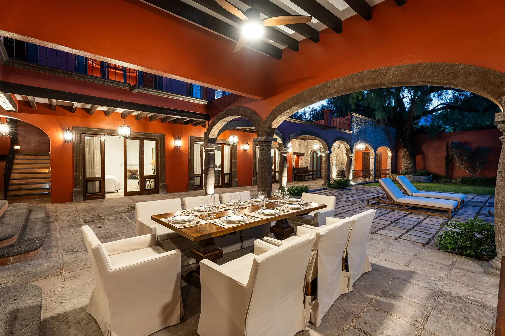Casa Del Cardo, arcaded courtyard with an outdoor dining table set for a meal, San Miguel de Allende