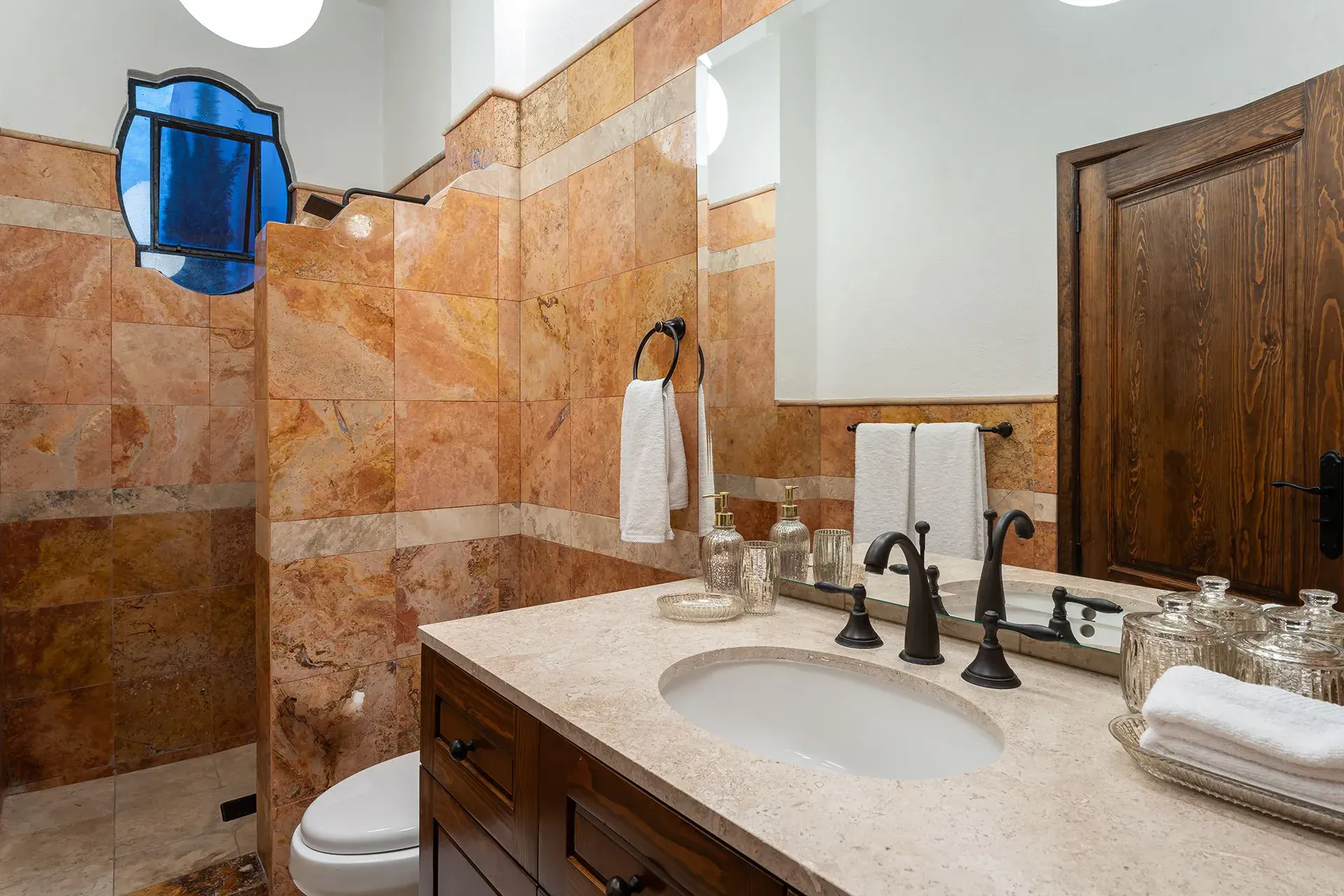 Casa Del Cardo, bathroom with a stone vanity and terracotta tile walls, San Miguel de Allende
