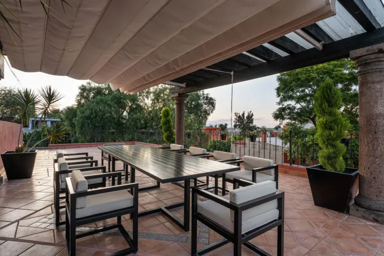 Casa Del Cardo, covered terrace with a long dining table and treetop views, San Miguel de Allende