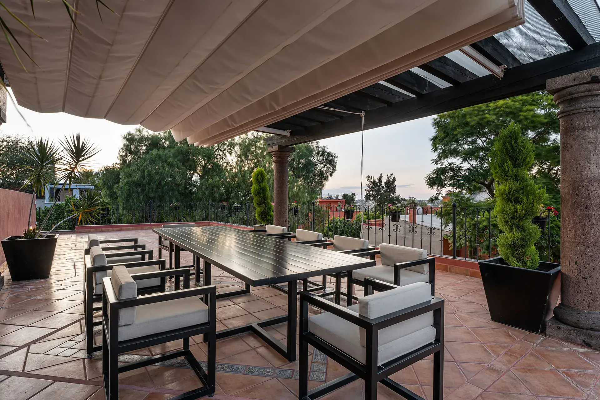 Casa Del Cardo, covered terrace with a long dining table and treetop views, San Miguel de Allende