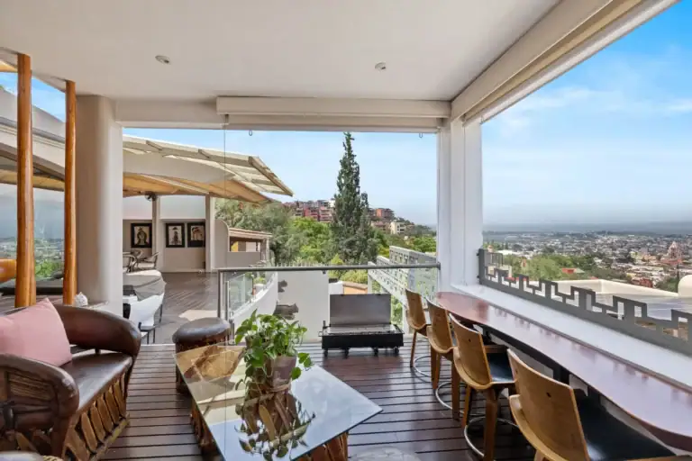 Casa del Foro, terrace lounge with leather equipale chairs, a bar counter with stools and a view of the valley, San Miguel de Allende