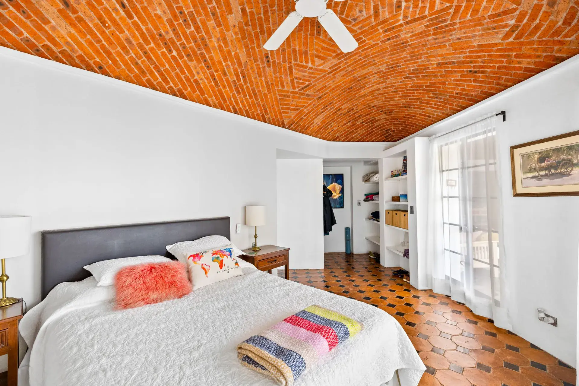 Casa del Foro, bedroom with a brick vaulted ceiling, a gray headboard and an octagonal tile floor, San Miguel de Allende