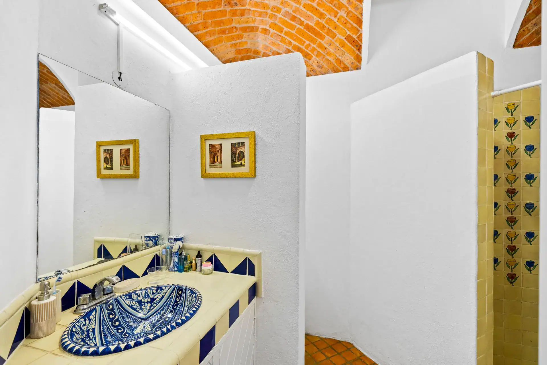 Casa del Foro, bathroom with a hand-painted Talavera sink, yellow tile and a walk-in shower, San Miguel de Allende