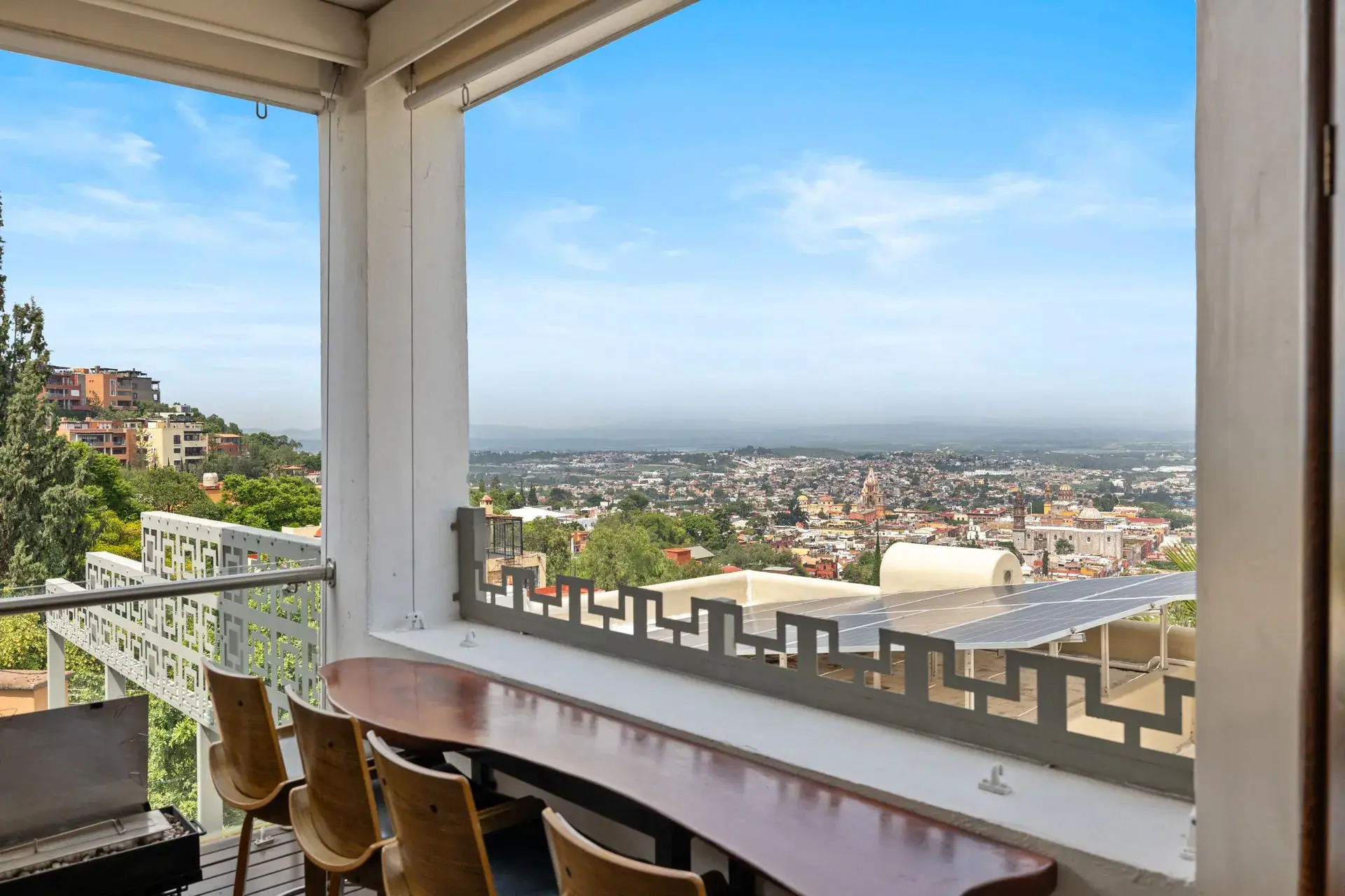 Casa del Foro, bar counter on the terrace railing with stools and a view over the town, San Miguel de Allende