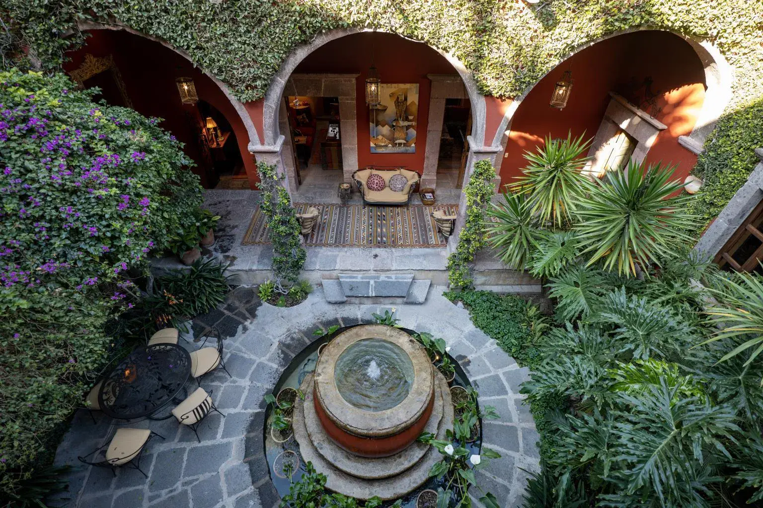 Casa Diana, aerial view of the courtyard fountain surrounded by plants and arches, San Miguel de Allende
