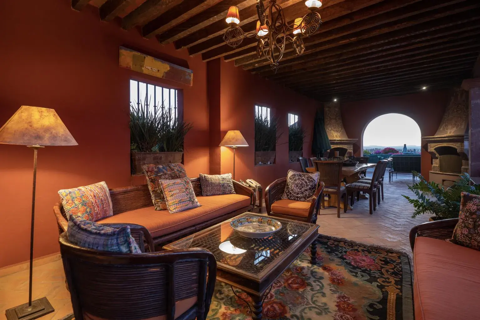Casa Diana, covered terrace living area with a fireplace and a view at dusk, San Miguel de Allende