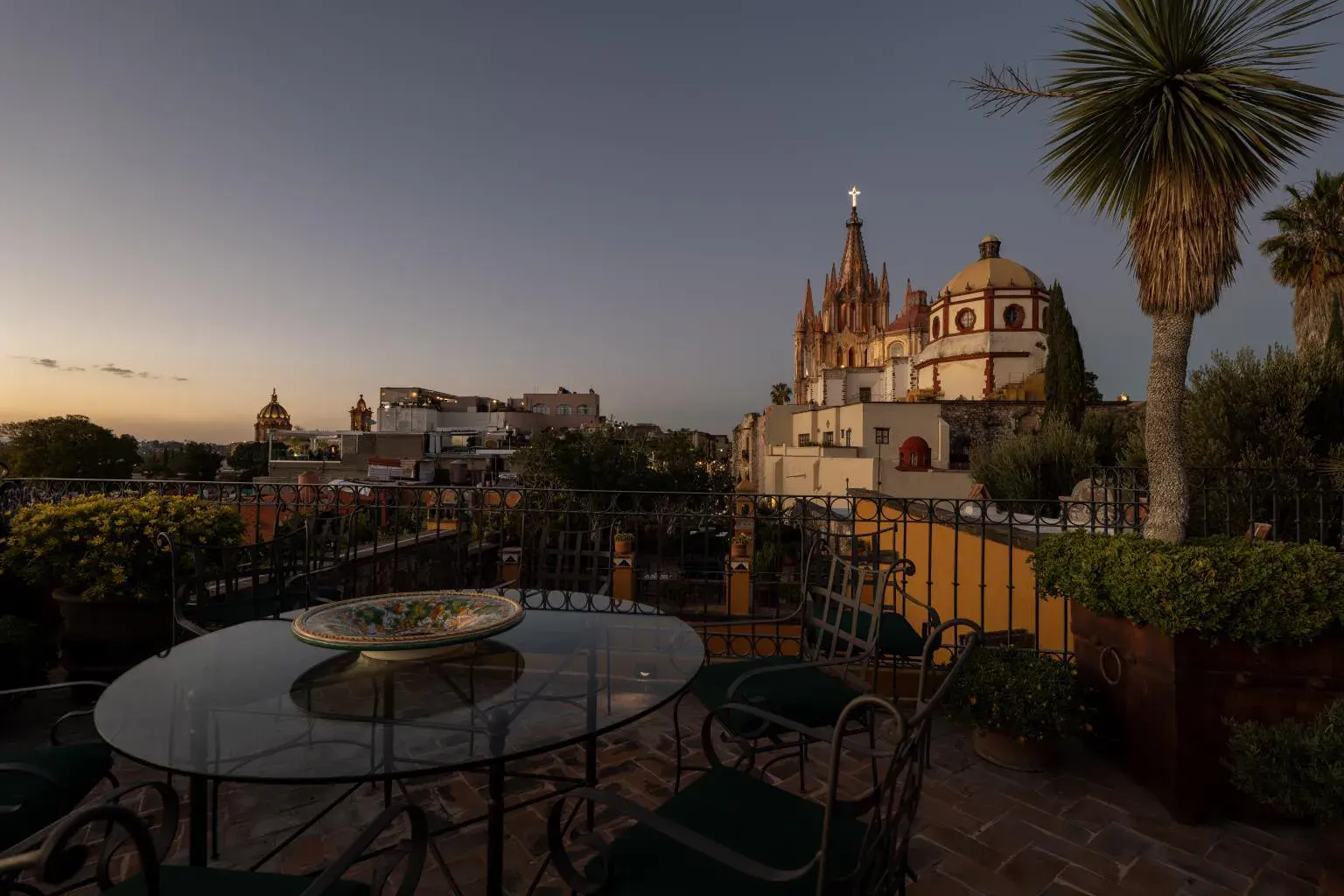 Casa Diana, rooftop dining table with the Parroquia at sunset, San Miguel de Allende