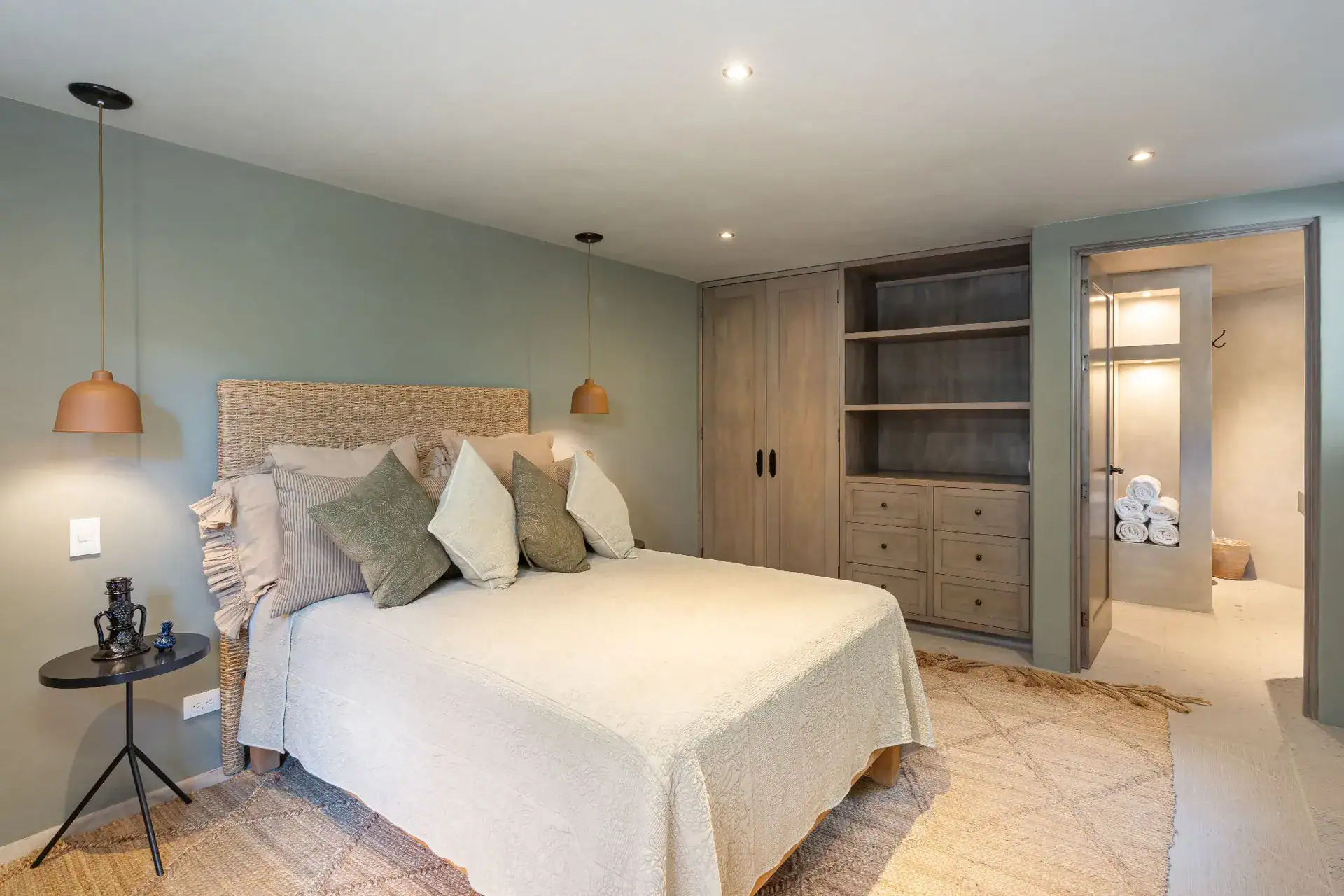 Casa Dos Casas, bedroom with a white bed, built-in cabinets and an en suite bathroom, San Miguel de Allende