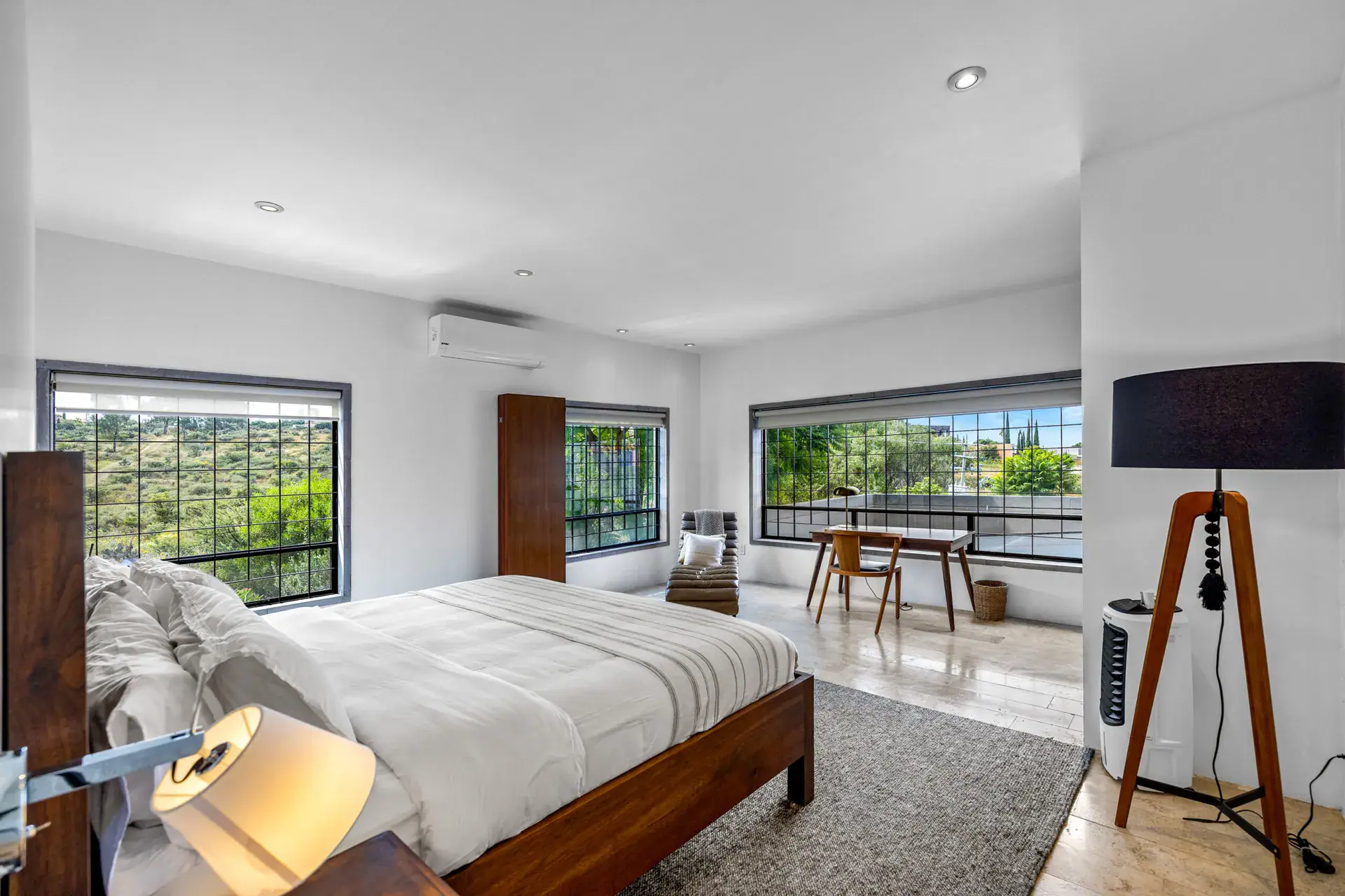 Casa Dos Gatos, bedroom with a window wall to the landscape, a bed and a floor lamp, San Miguel de Allende