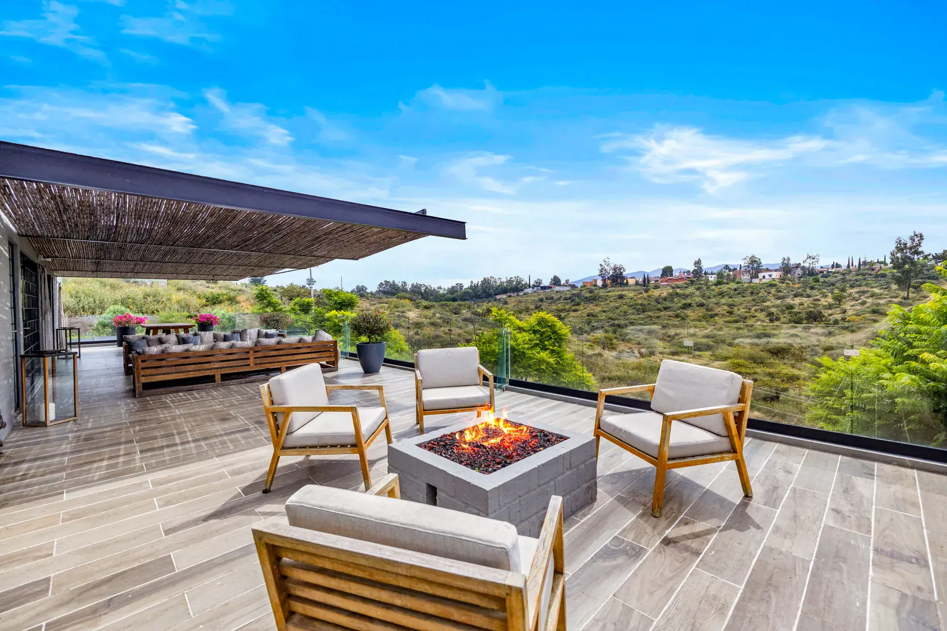 Casa Dos Gatos, terrace with a fire pit, white armchairs and a view over the valley, San Miguel de Allende