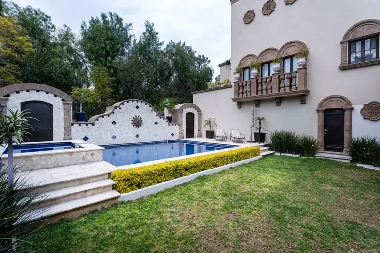 Casa Elegante, courtyard pool with a mosaic tile wall and a lawn, San Miguel de Allende