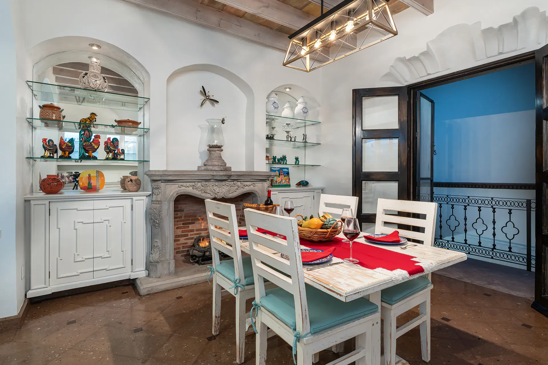 Casa Elegante, kitchen dining table with white chairs and glass shelves, San Miguel de Allende