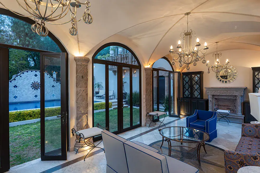 Casa Elegante, vaulted garden room with chandeliers and arched glass doors, San Miguel de Allende