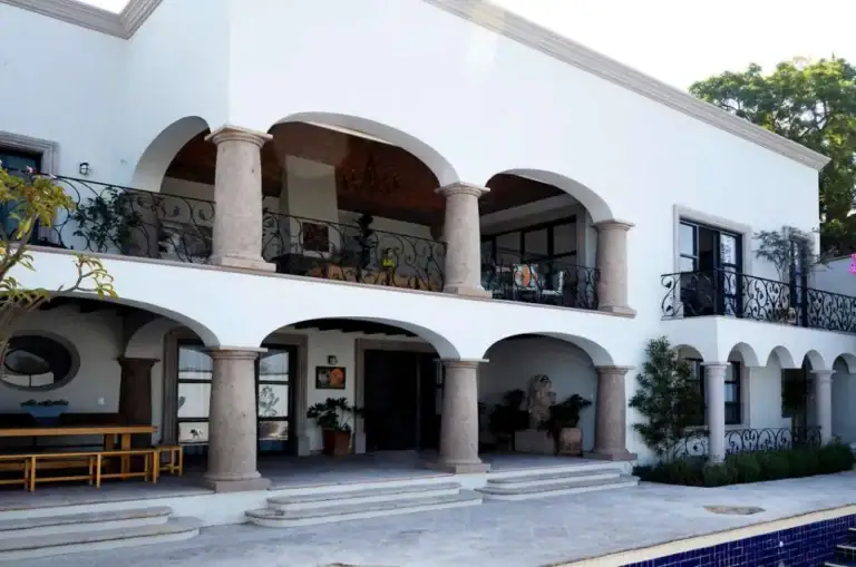 Casa Eloísa, white two-story facade with stone arches and a wrought-iron balcony, San Miguel de Allende