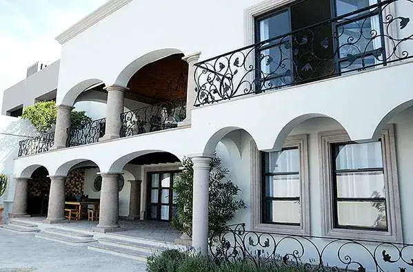 Casa Eloísa, arcaded white facade with stone columns and a pool, San Miguel de Allende