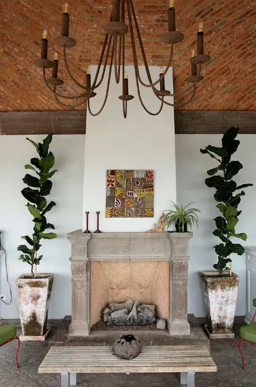 Casa Eloísa, terrace fireplace with a stone surround and a chandelier, San Miguel de Allende