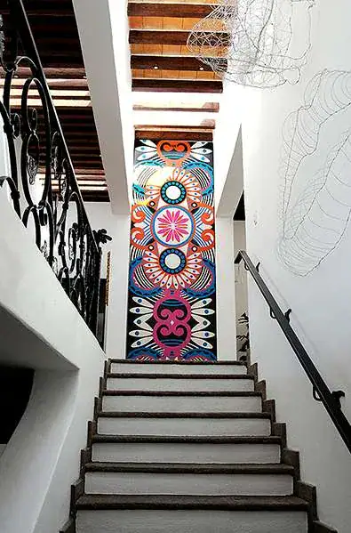 Casa Eloísa, staircase with a colorful patterned wall mural, San Miguel de Allende
