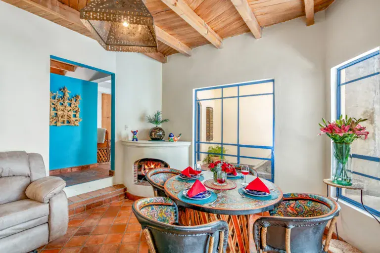 Casa Fallingwater, dining area with a corner fireplace and a turquoise niche, San Miguel de Allende