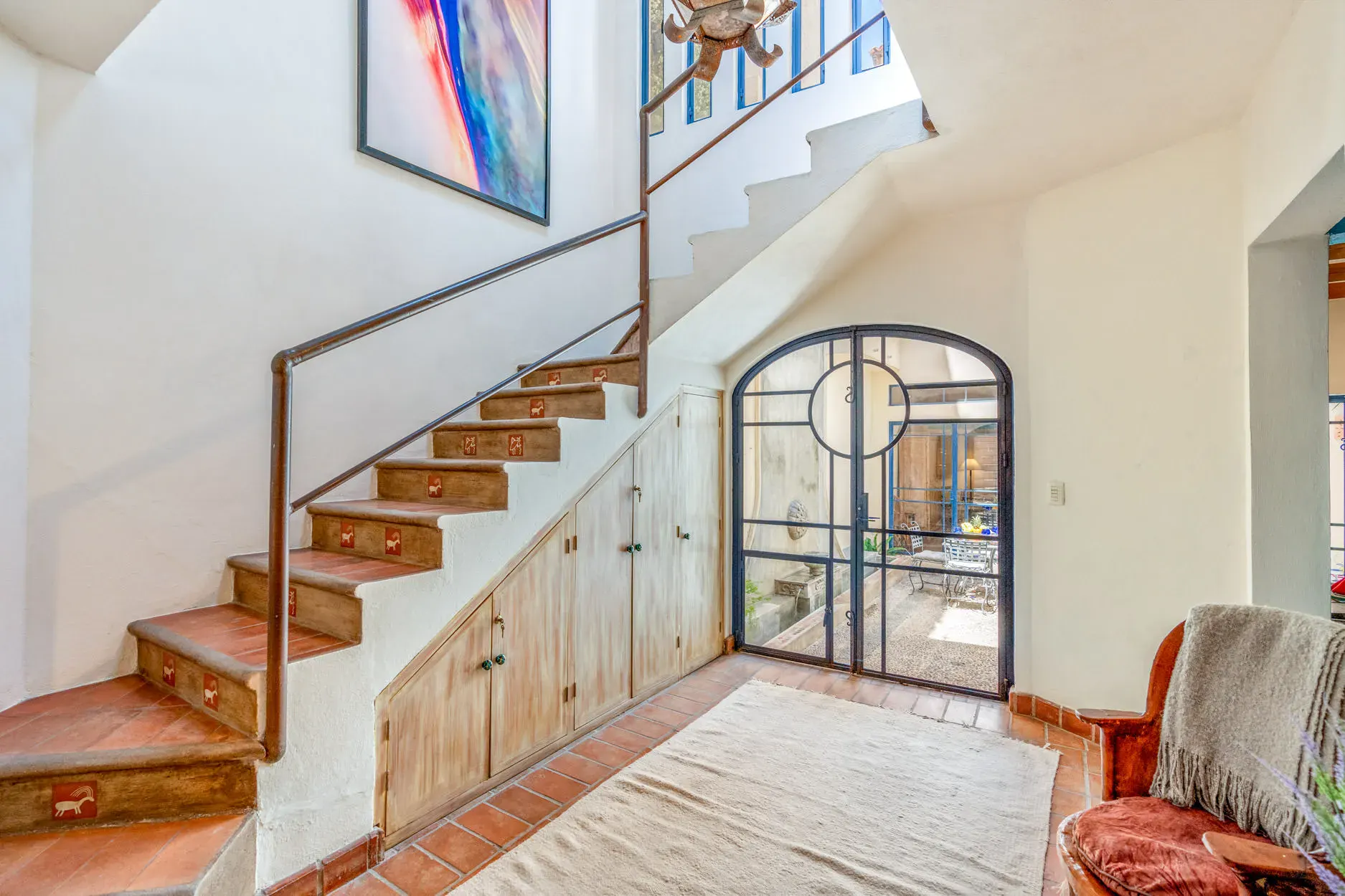 Casa Fallingwater, entry stair with a black steel arched door, San Miguel de Allende