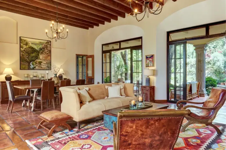 Casa Familia, living room with a cream sofa, beamed ceiling and glass doors to the garden, San Miguel de Allende
