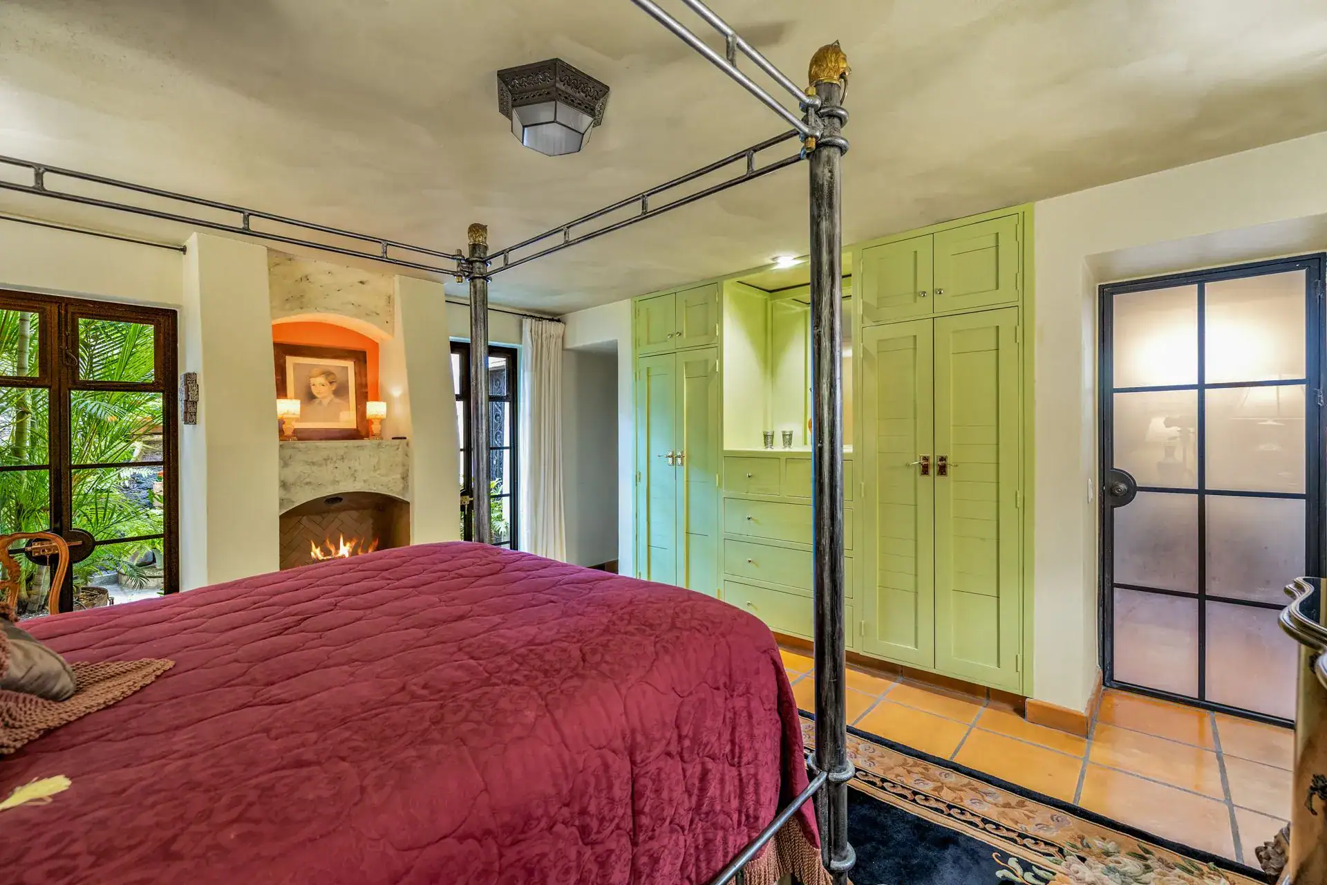 Casa Flora, bedroom with a canopy bed, a fireplace and green built-in closets, San Miguel de Allende