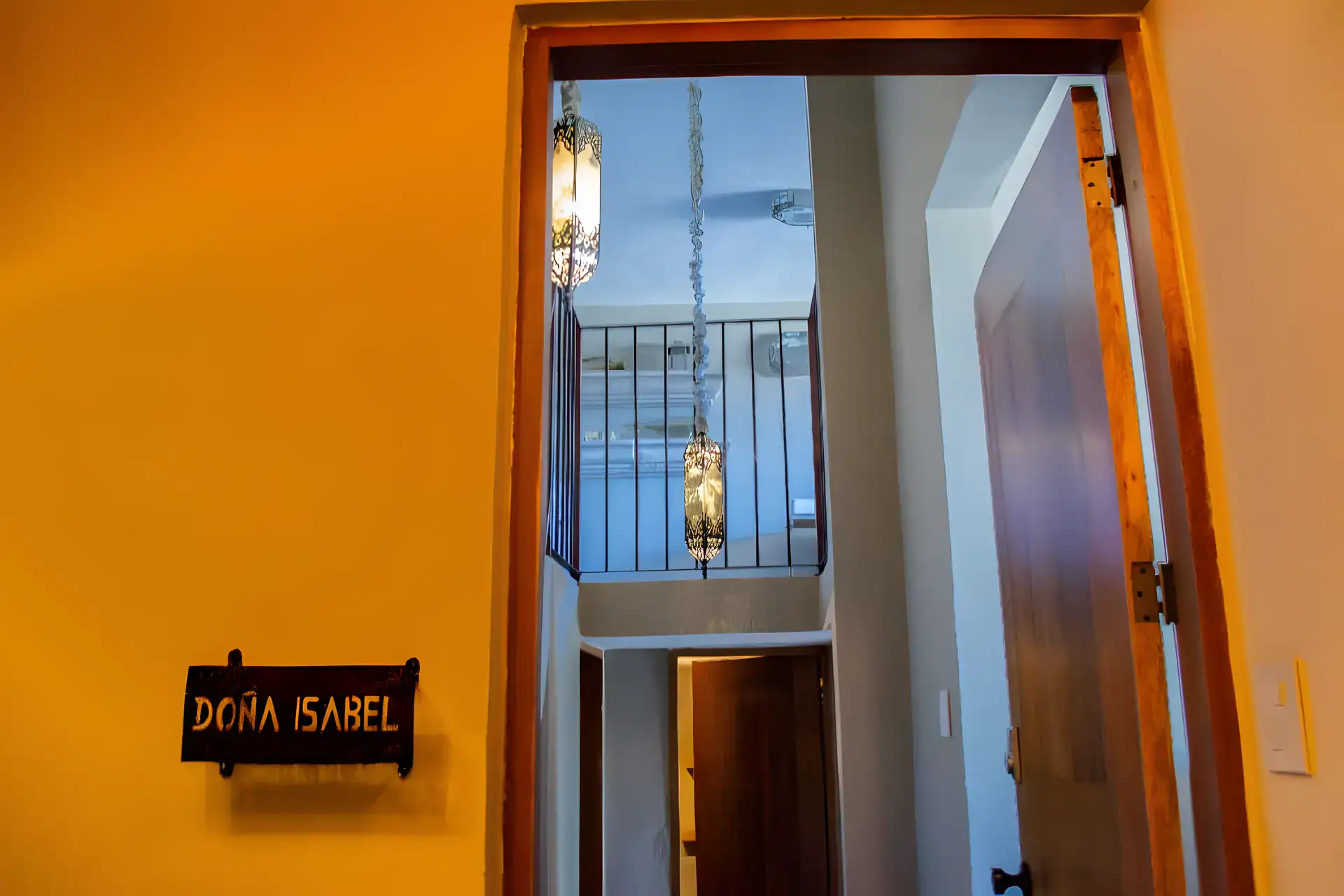 Casa Garza, doorway with a Doña Isabel name sign opening to a balcony and stairwell, San Miguel de Allende