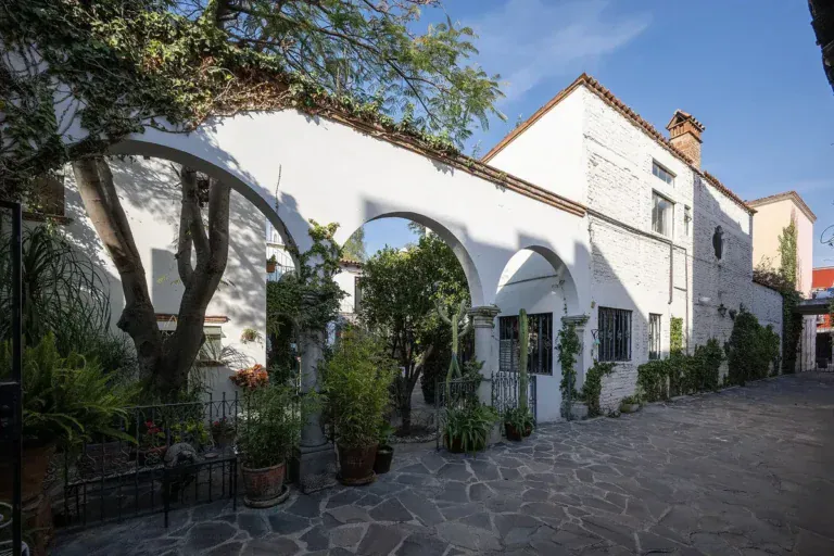 Casa Gracia, white arcade and courtyard with potted plants, San Miguel de Allende