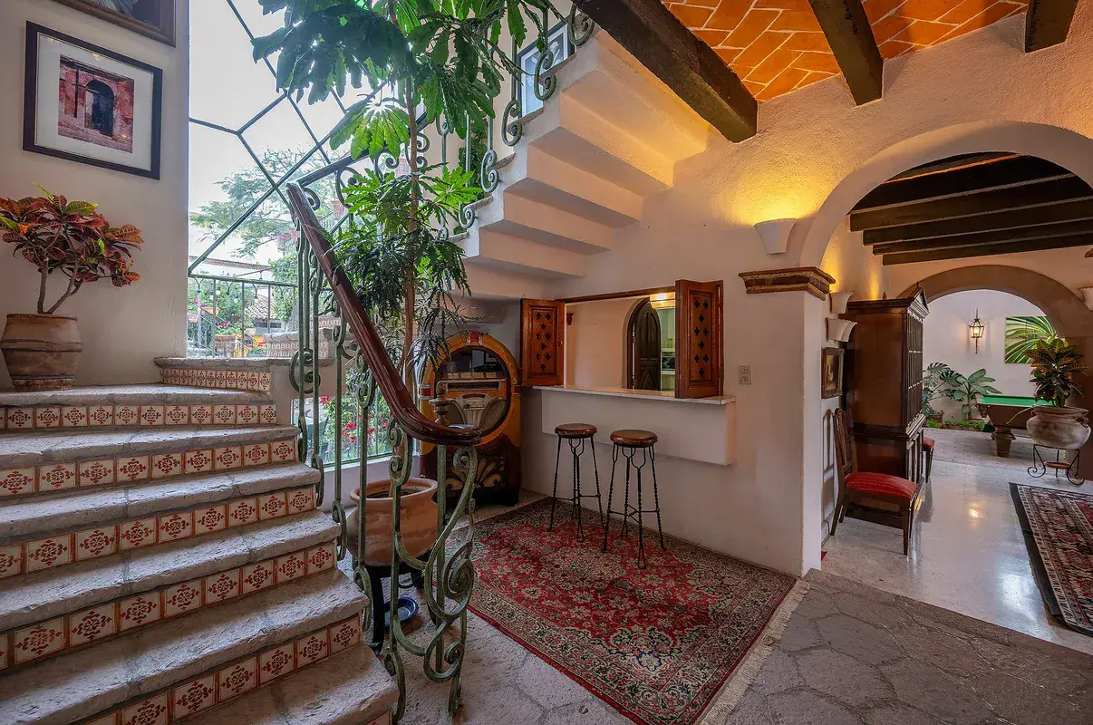Casa Gracia, staircase with tiled steps and a view into the dining area, San Miguel de Allende