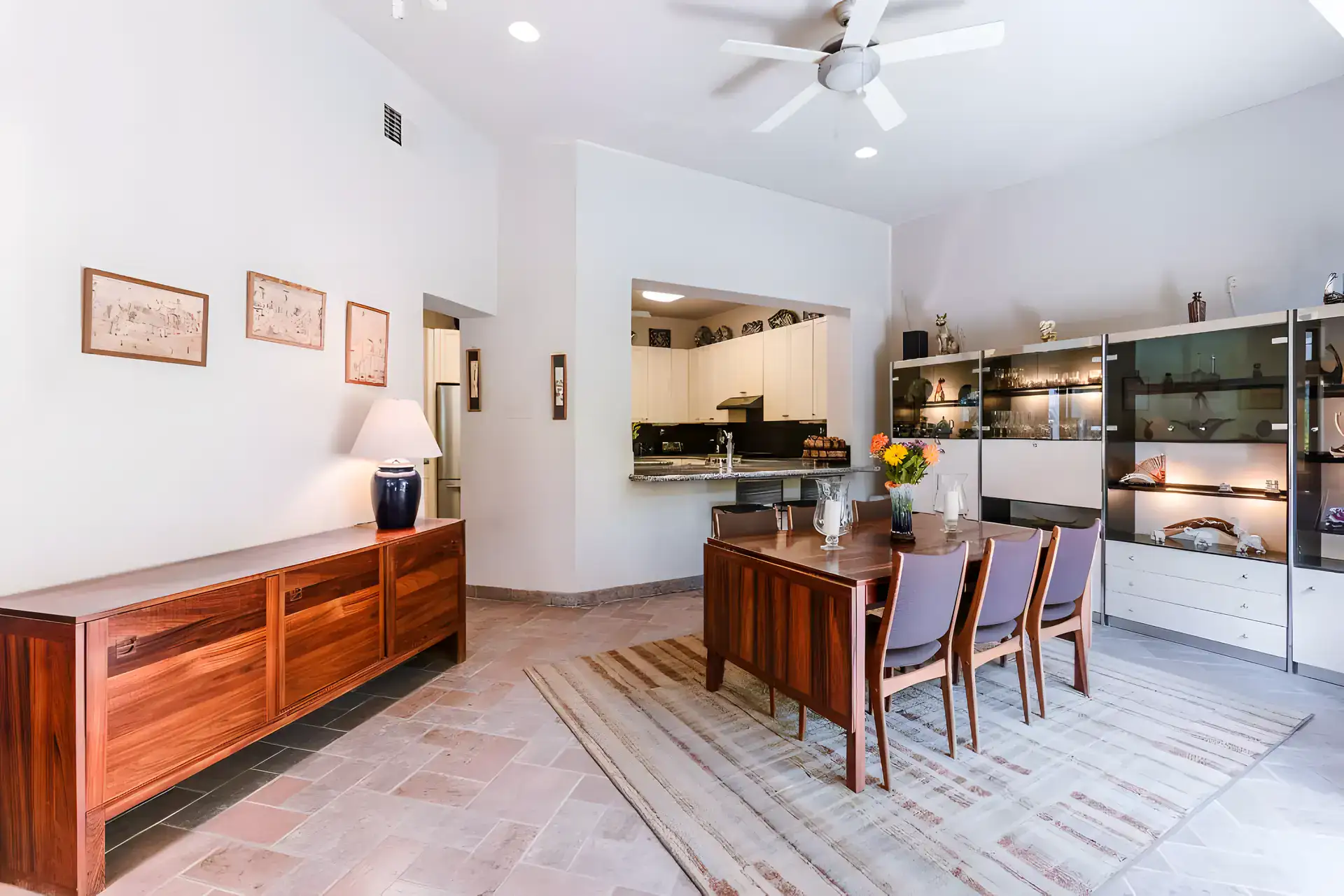 Casa Guadiana, dining table with blue chairs and a wood sideboard open to the kitchen, San Miguel de Allende