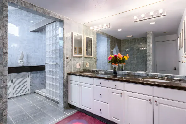 Casa Guadiana, bathroom with a granite double vanity, glass block wall and a marble shower, San Miguel de Allende
