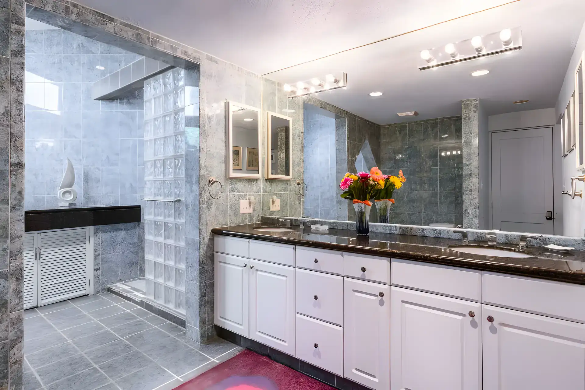 Casa Guadiana, bathroom with a granite double vanity, glass block wall and a marble shower, San Miguel de Allende
