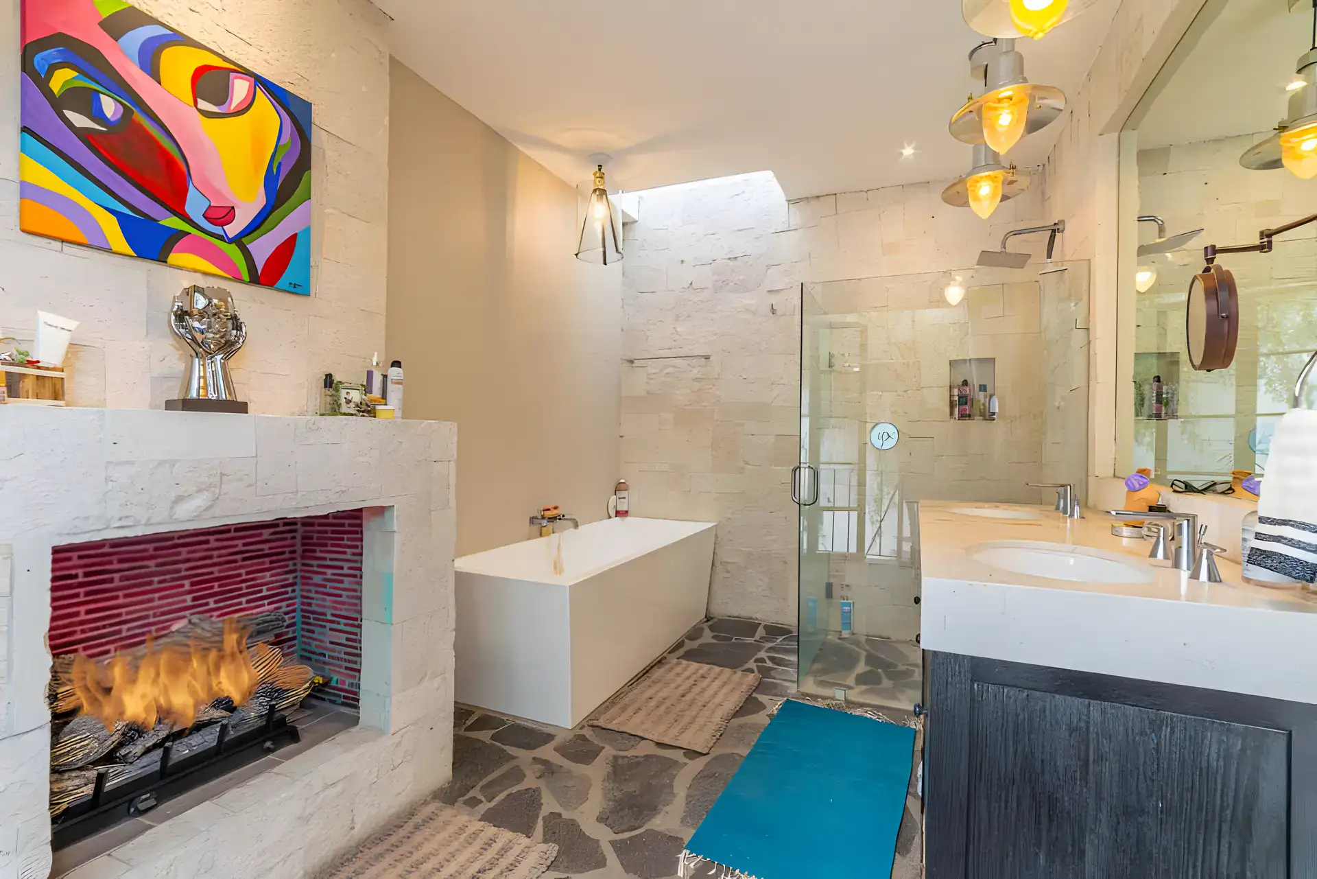 Casa Huerta, bathroom with a stone fireplace, a freestanding tub, a glass shower and a double vanity, San Miguel de Allende