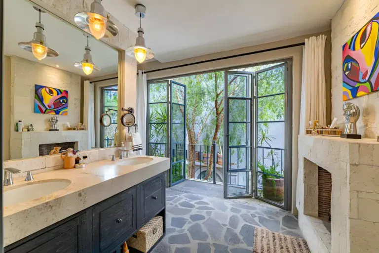 Casa Huerta, bathroom with a long stone double vanity, pendant lights and French doors to a balcony, San Miguel de Allende