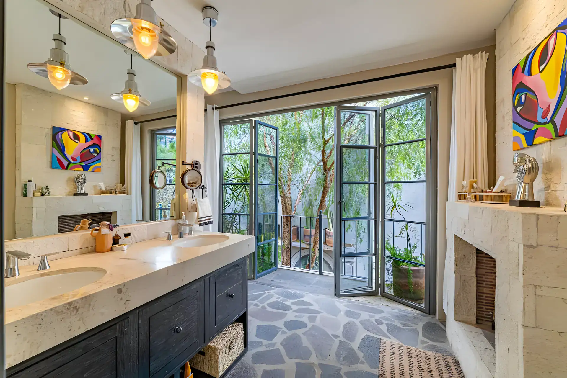 Casa Huerta, bathroom with a long stone double vanity, pendant lights and French doors to a balcony, San Miguel de Allende