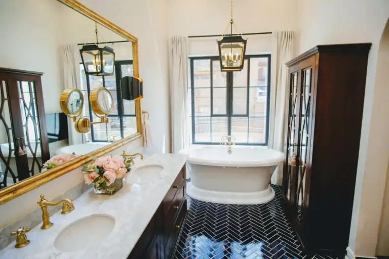 Casa Jacaranda, primary bathroom with a freestanding tub, double vanity and gold mirror, San Miguel de Allende