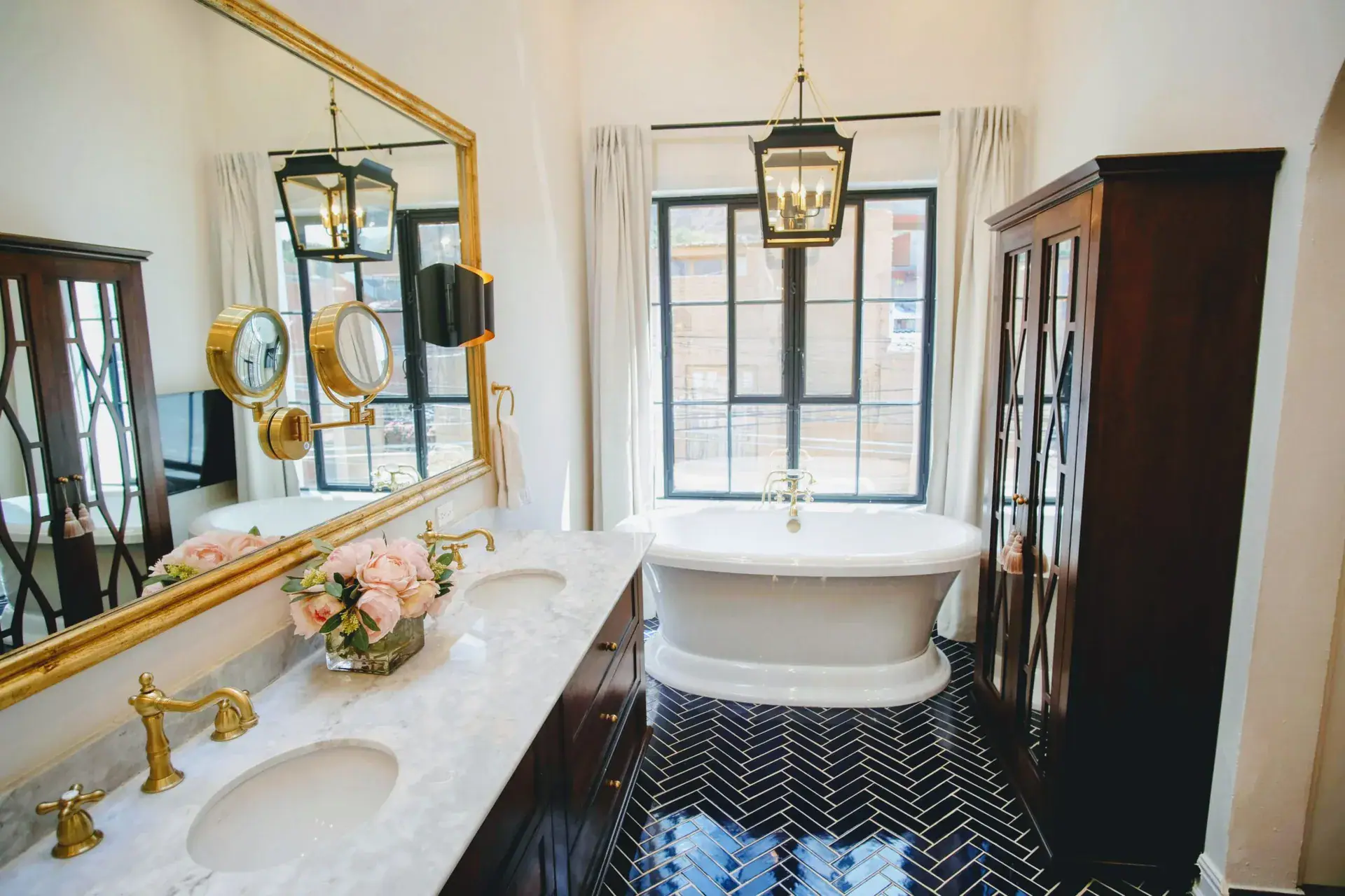 Casa Jacaranda, primary bathroom with a freestanding tub, double vanity and gold mirror, San Miguel de Allende