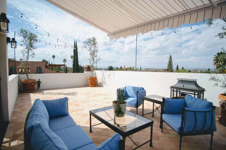 Casa Jacaranda, rooftop terrace with blue sofas and an awning, San Miguel de Allende