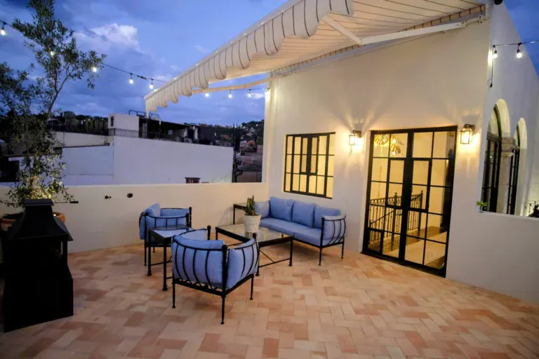 Casa Jacaranda, rooftop terrace at dusk with string lights and views, San Miguel de Allende