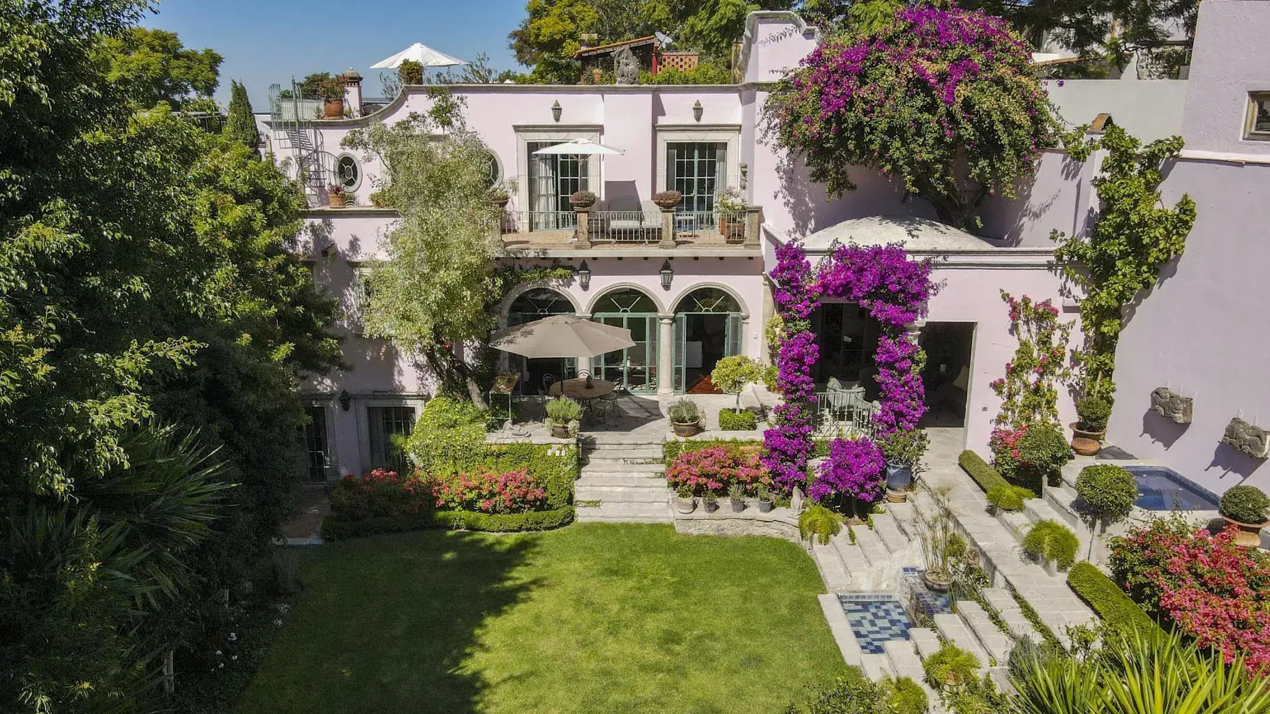 Casa Jardín, pink house above a terraced garden with bougainvillea and a lawn, San Miguel de Allende