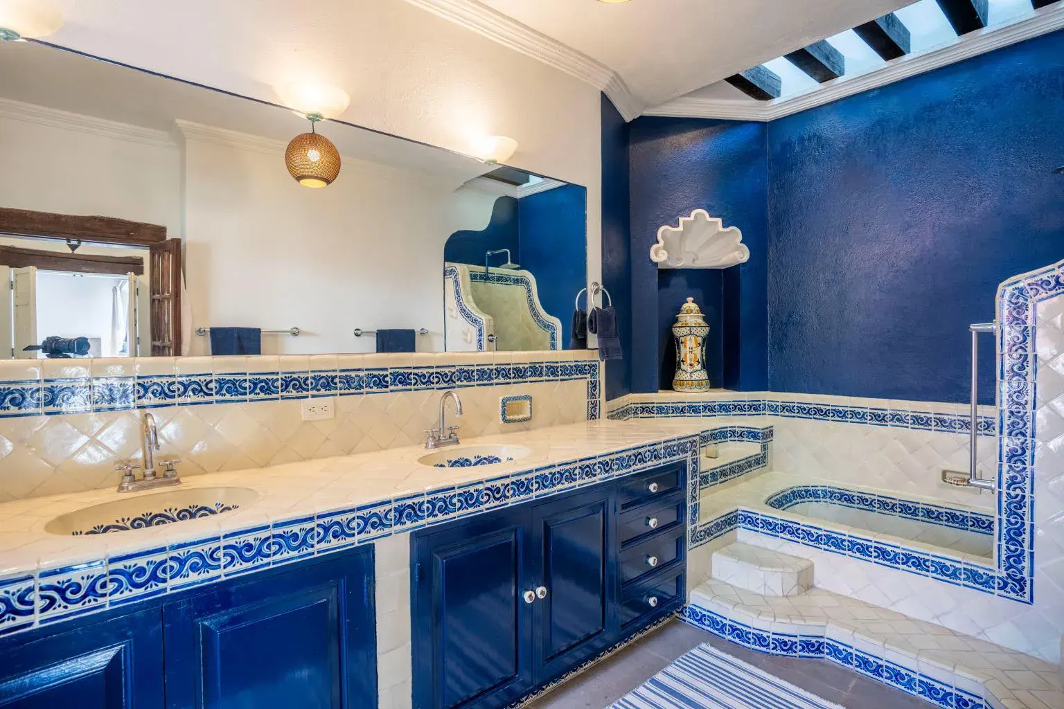 Casa Jardín, bathroom with blue cabinets, talavera tile and a sunken tub, San Miguel de Allende