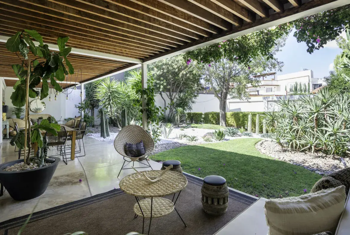 Casa Juan Guadiana, covered loggia with a slatted wood ceiling opening to the lawn, San Miguel de Allende