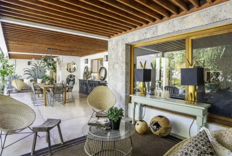 Casa Juan Guadiana, open living and dining area with a stone wall and slatted ceiling, San Miguel de Allende