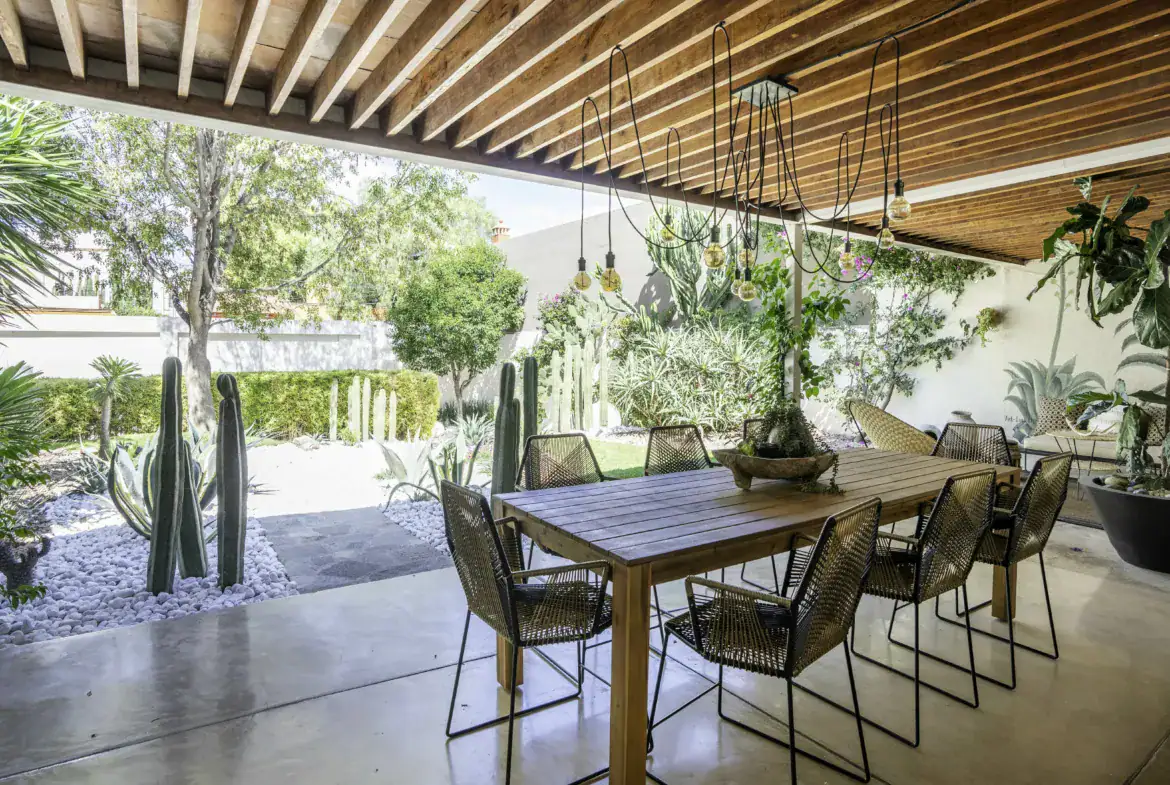 Casa Juan Guadiana, outdoor dining table beside cacti under a wood ceiling, San Miguel de Allende